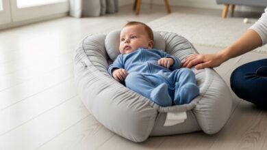 Baby lounger positioned safely on floor with infant lying on back under parent supervision
